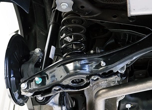 Suspension and brake assembly seen from under a car on the lift