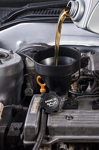 Engine oil being poured during a service